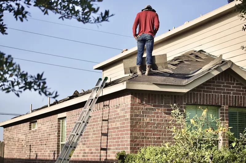 Professional roofer working on a residential roof in Port Neches